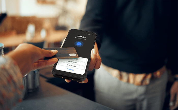 Guest paying by card on a Shift4 Dine handheld